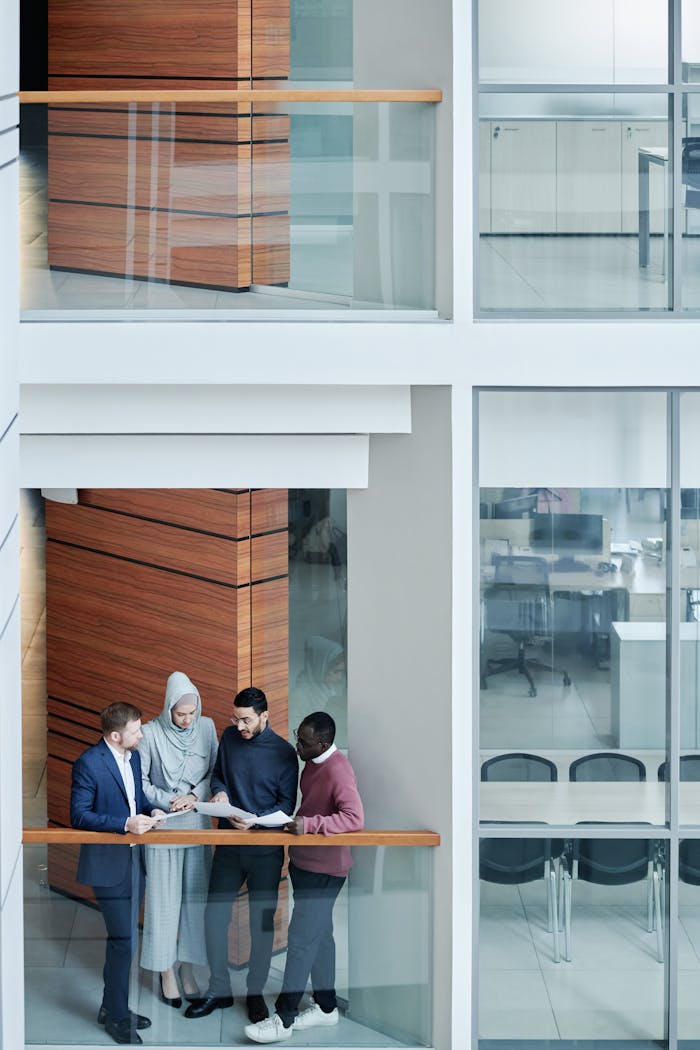 A diverse group of business professionals having a meeting in a modern office setting.